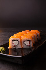 Traditional roll on the plate, black background. Copy space