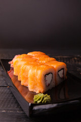 Traditional roll on the plate, black background. Copy space