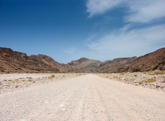 wadi road towards hills in oman