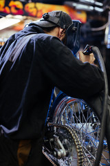 Repairman in protective eyewear welding in workshop