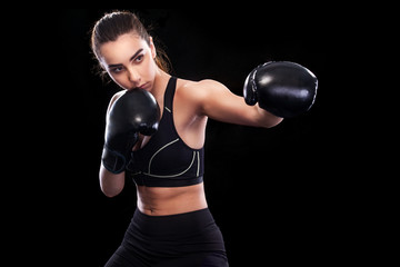 Sportsman muay thai boxer fighting. Isolated on black background. Copy Space.