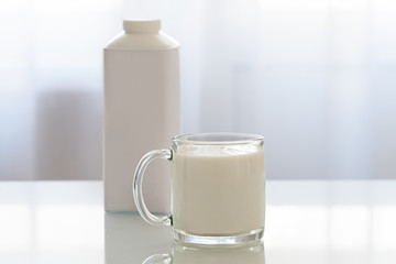 Glass Cup with yogurt on a white table