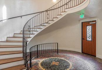vintage spiral staircase with modern light and mosaic floor