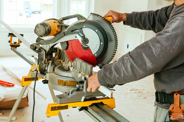 man cutting wood on electric saw