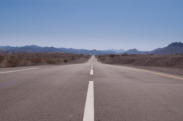 empty asphalt road disappearing in distance