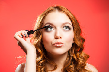 Young woman applying make up