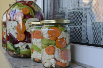 Pickled organic vegetables in glass jars