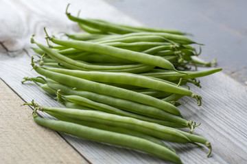 Bunch of fresh beans on the wooden background