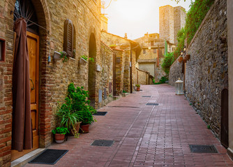 Old cozy street in San Gimignano, Tuscany, Italy. San Gimignano is typical Tuscan medieval town in Italy