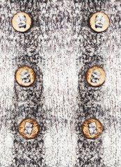 wool fabric warm soft with two rows of bamboo wooden buttons located in the background