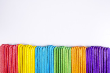 Colourful wooden sticks on white background
