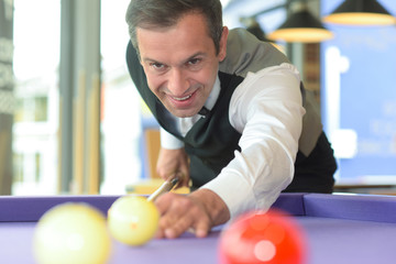 man playing billiards