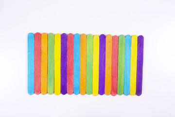 Colourful wooden sticks on white background