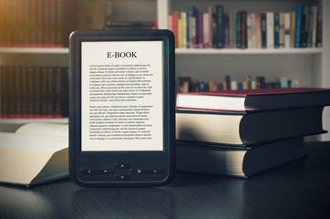 E-book reader device on desk in library
