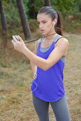 Young female athlete holding stopwatch