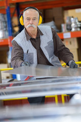 Senior man working wearing earmuffs