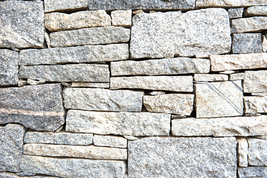 Textured pattern of a granite stone wall
