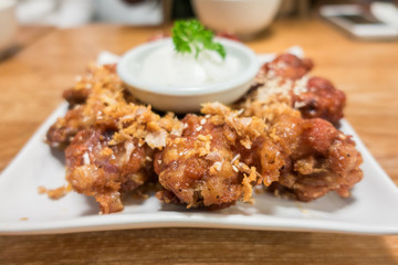Korean style spicy sauce deep fried chicken wing serve ..top view with copy space.selective focus