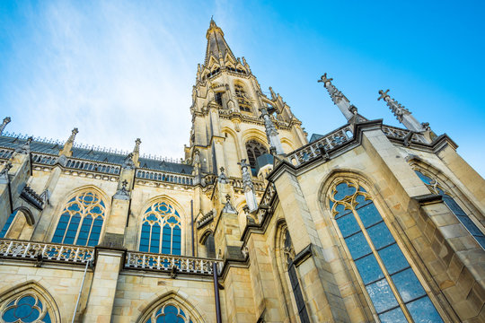 Spire of the New Dome gothic cathedral in Linz, low angle view, blue sky, close up of architectural details