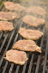 Marinated pork chops on the barbecue grill.