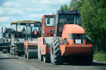 Tractor, roller , truck on the road repair site. Road construction equipment. Road repair concept.