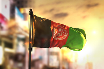 Afghanistan Flag Against City Blurred Background At Sunrise Backlight © natanaelginting