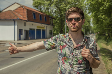 Young man stopping the car on the road