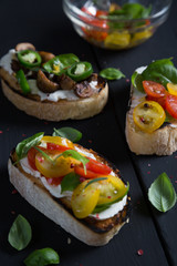 Bruschetta with cherry tomatoes, cream cheese, mushrooms, basil