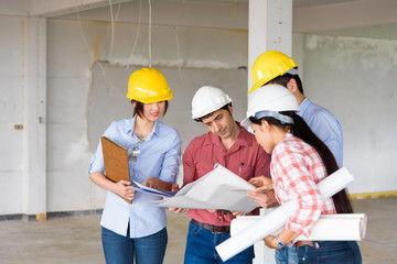 Group of Multiethnic engineers meeting about their project in construction site. Engineer...