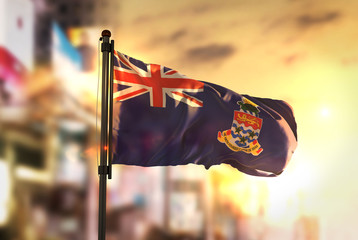 Cayman Islands Flag Against City Blurred Background At Sunrise Backlight © natanaelginting