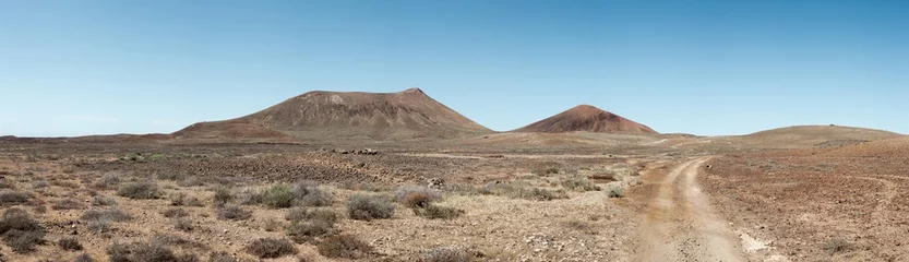 Zelfklevend Fotobehang Off road track in the middle of dry, barren, volcanic landscape, the Canary Islands © melecis