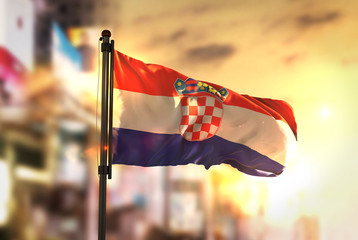 Croatia Flag Against City Blurred Background At Sunrise Backlight