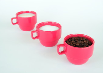 Three cups with coffee sugar and milk