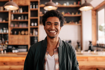 Smiling young man in a coffee shop