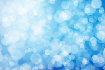 abstract blurred background bokeh blue lights with sun light ray.