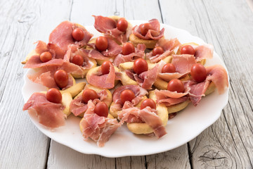 Christmas appetizer with tomatoes and ham bread