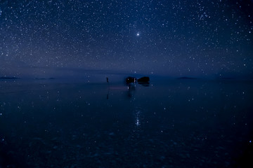 Stars reflect surface of water at Uyuni Salt flats in Bolivia.