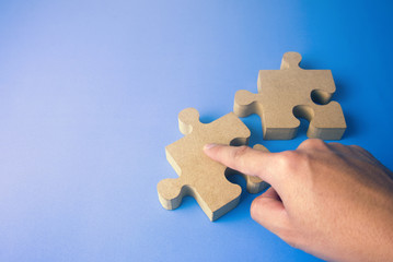 Fototapeta premium hand with wood jigsaw