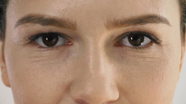 Facial Care. Beautiful Woman Massaging Skin Under Eyes