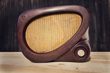 Old brown vintage bakelite Tesla radio on wooden background
