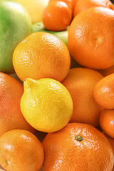 Heap of juicy citrus fruits and apples, closeup