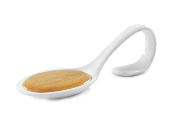 Spoon with delicious mustard sauce isolated on white