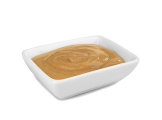 Bowl of delicious mustard sauce isolated on white