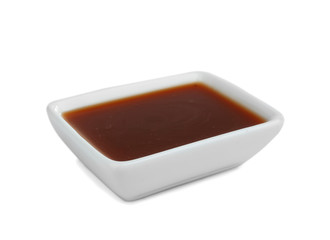Bowl of delicious caramel sauce isolated on white
