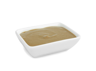 Bowl of delicious mustard sauce isolated on white