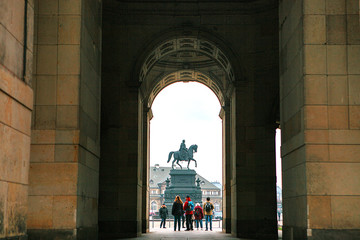 Equestrian Statue of King John of Saxony Konig Johann I. von Sachsen at Theaterplatz in Dresden, Germany. View through the arch.