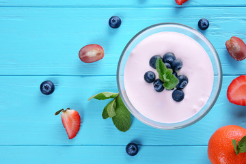 Naklejka na ściany i meble Composition with tasty homemade yogurt and ingredients on blue background