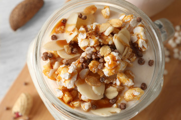 Delicious parfait with granola in jar, closeup
