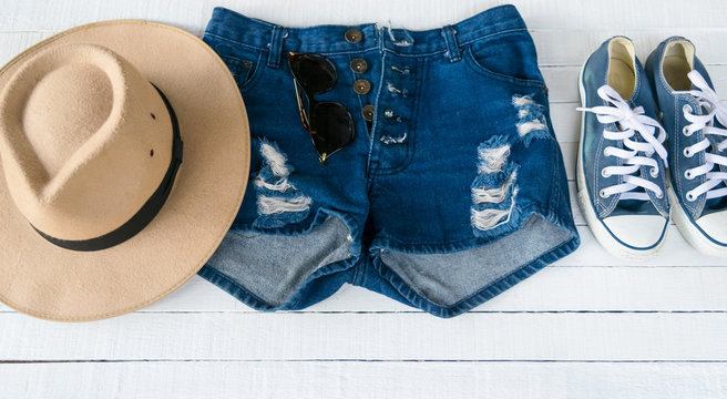 Dress Accessories women Jeans and hats sunglasses shoes on a white background.