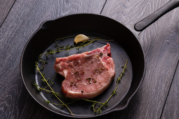 raw pork chop in pan